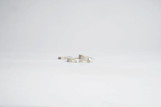 Silver bracelet on a light gray background