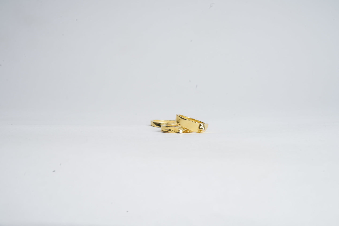 Gold ring with a unique design on a white background