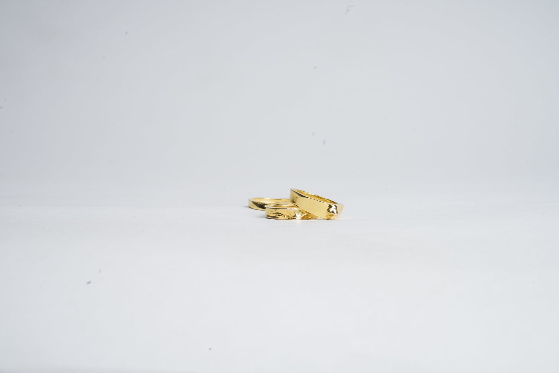 Gold ring with a unique design on a white background