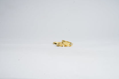 Gold ring with a unique design on a white background