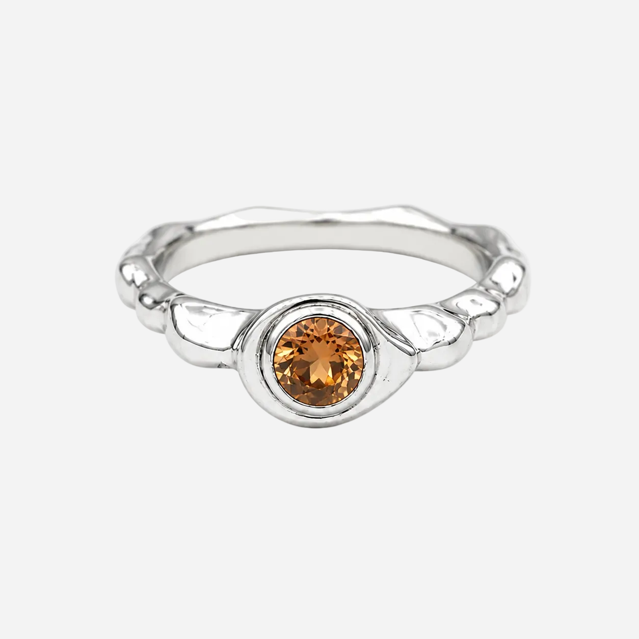 Silver ring with a brown gemstone on a white background