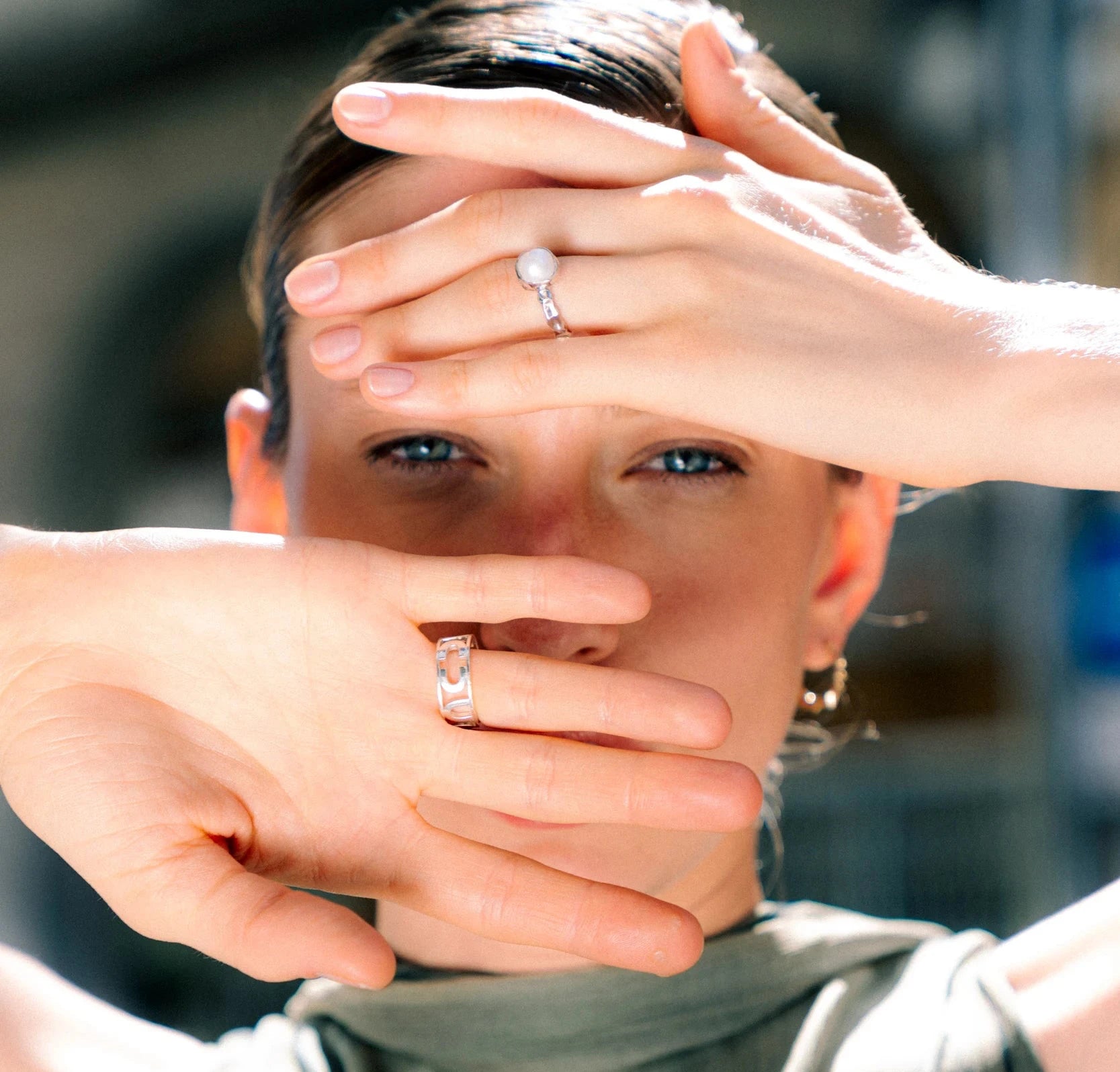 Person wearing two rings with a blurred background