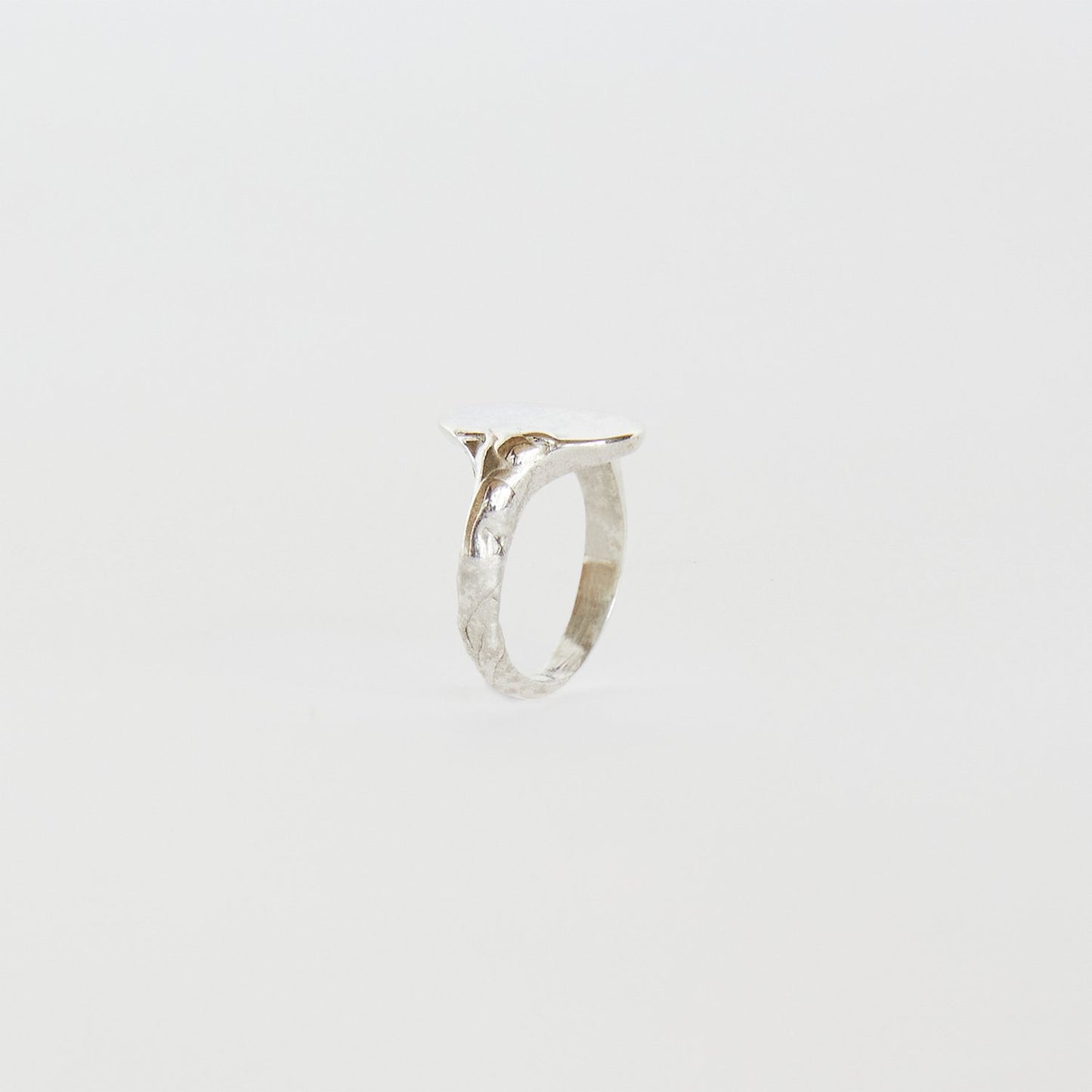 Silver ring on a light gray background