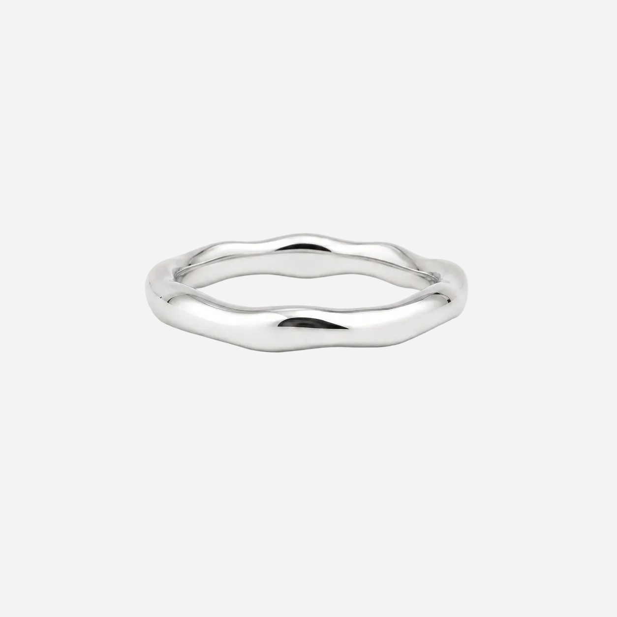 Silver ring with a wavy design on a white background