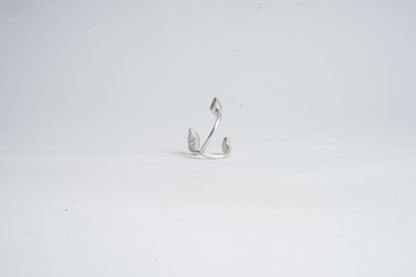 Silver earring on a light gray background