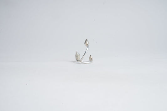 Silver earring on a light gray background