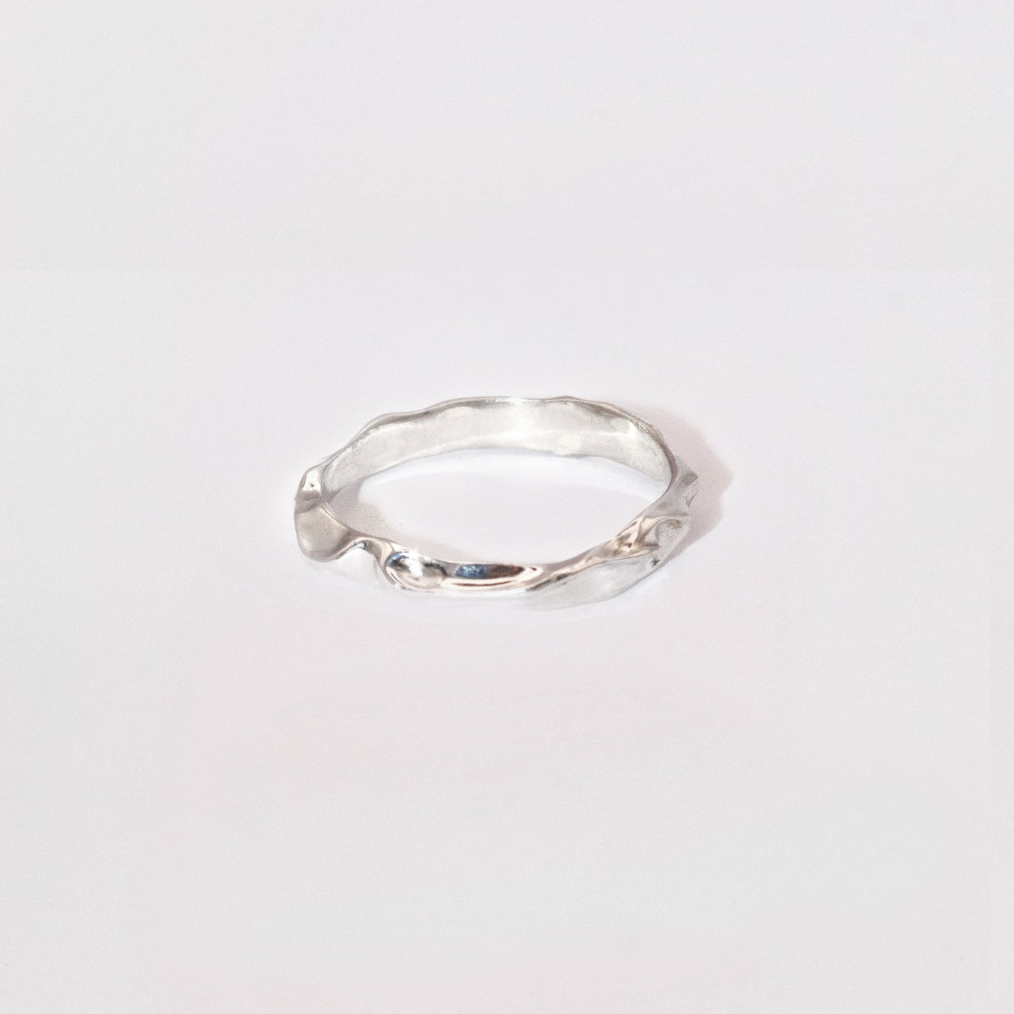 Silver ring on a light gray background