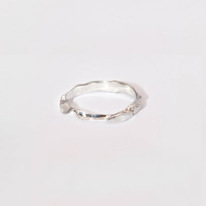 Silver ring on a light gray background
