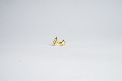 Gold ring on a light gray background