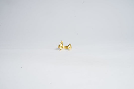 Gold ring on a light gray background