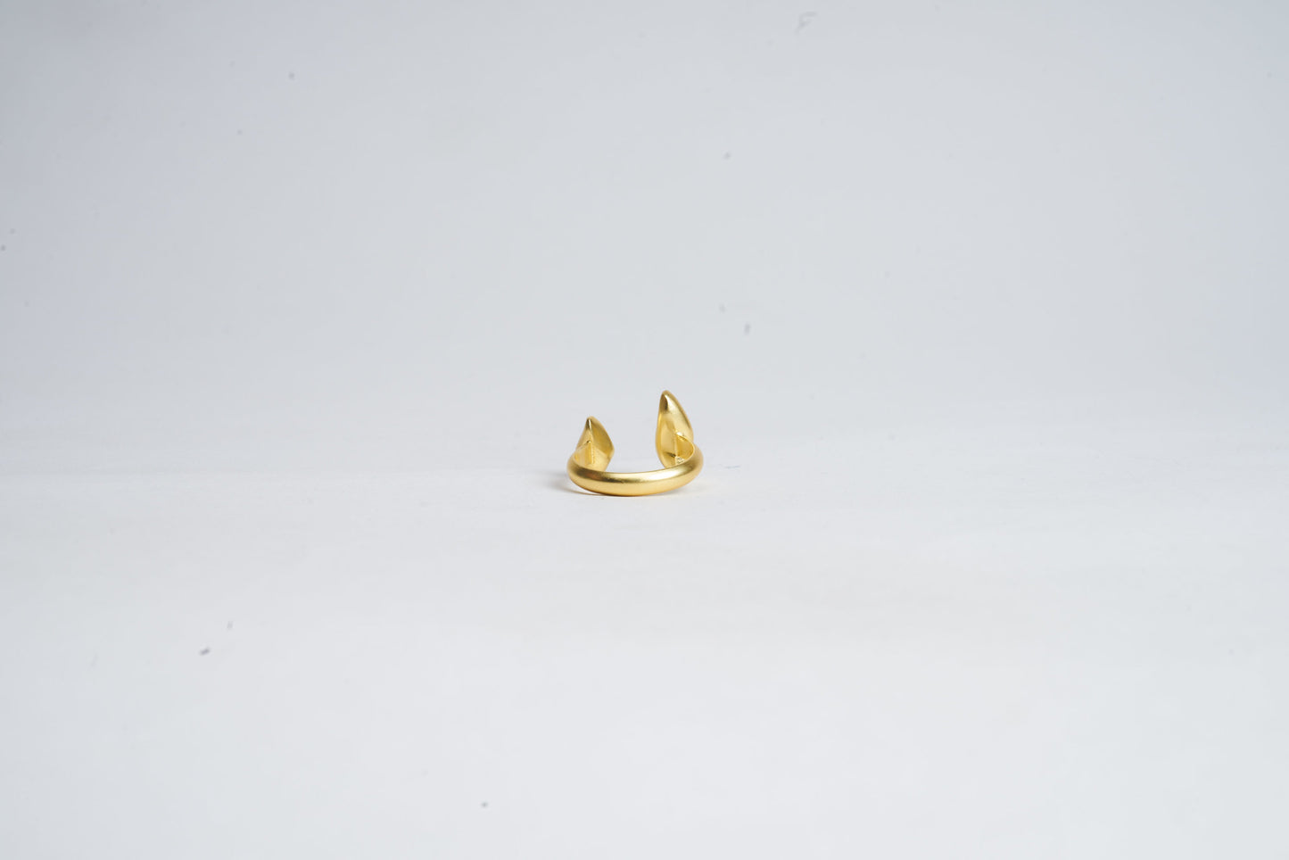 Gold ring on a light gray background