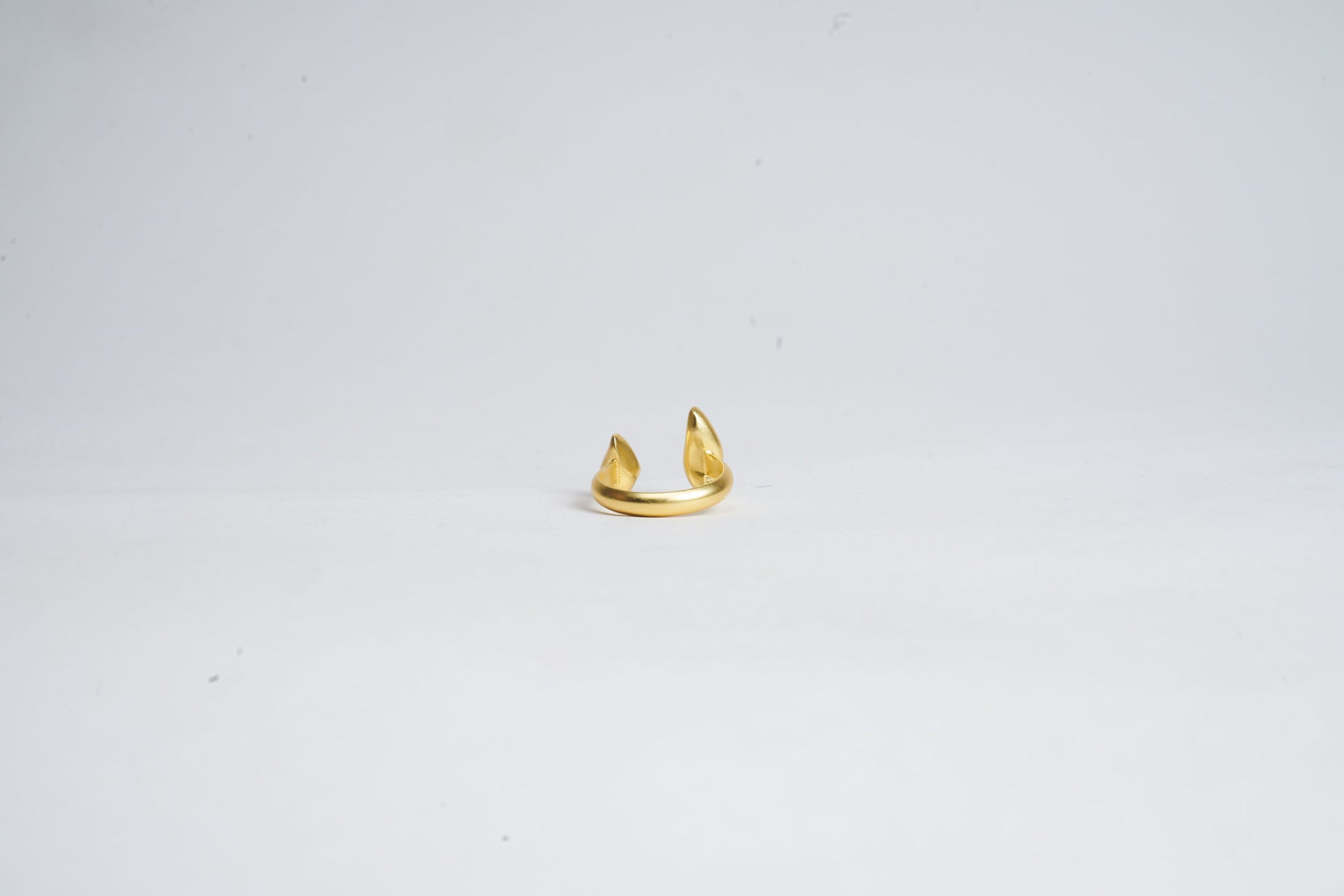 Gold ring on a light gray background
