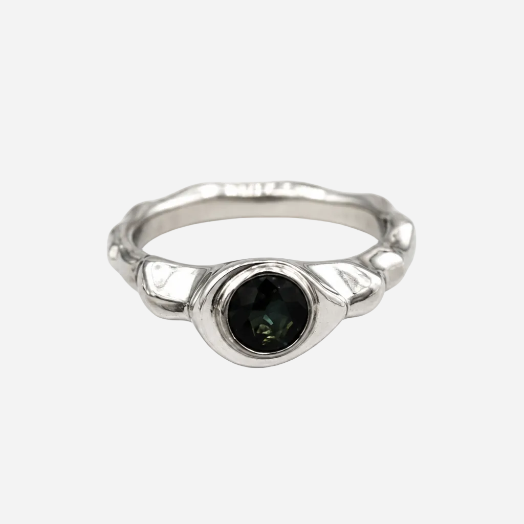 Silver ring with a black gemstone on a white background