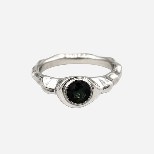 Silver ring with a black gemstone on a white background