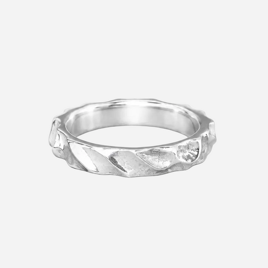 Silver ring with a textured band on a white background
